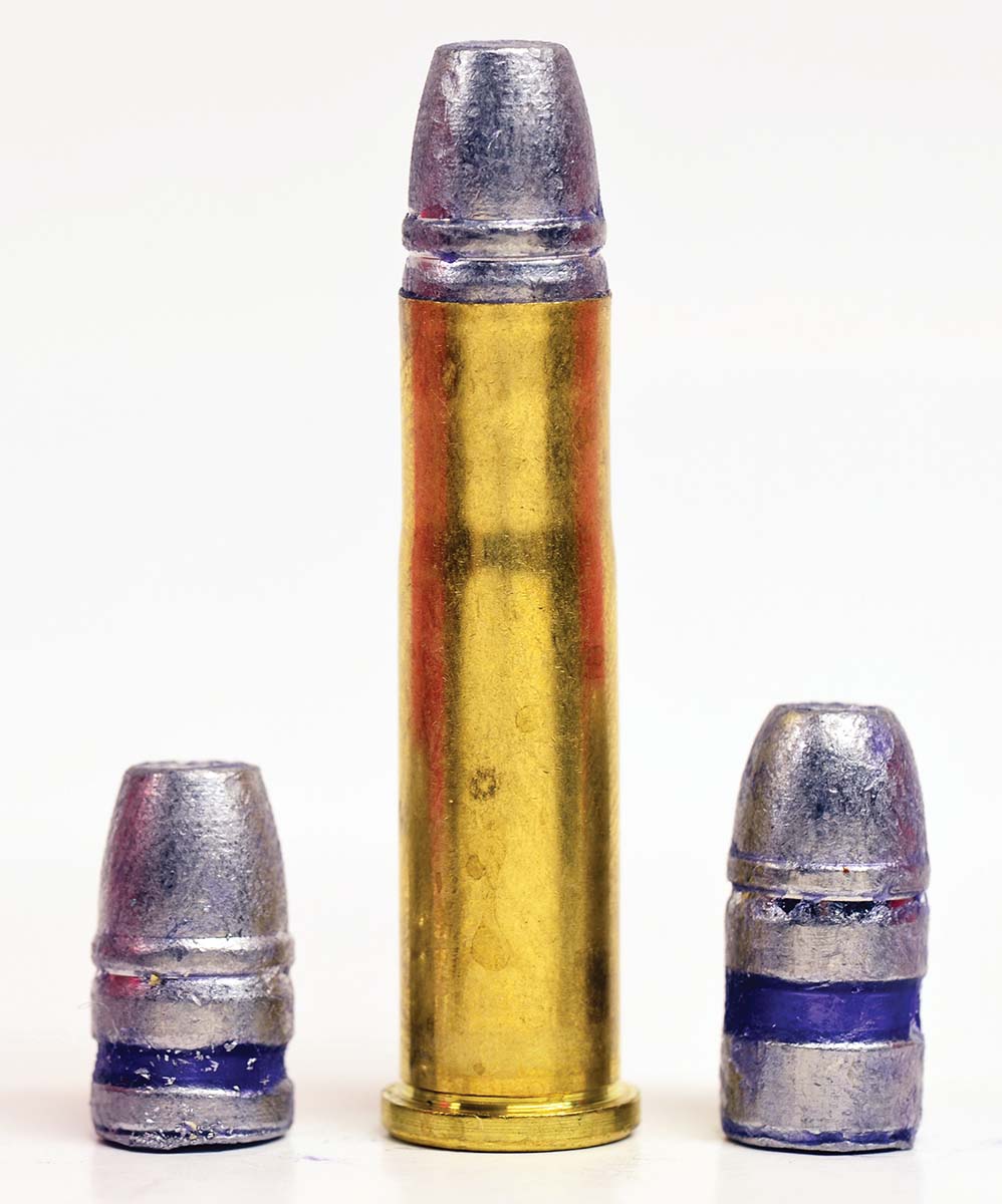 A 32-20 cartridge with two bullets:, a 100-grain (left) and a 120-grain (right). Both were lubricated for black powder.